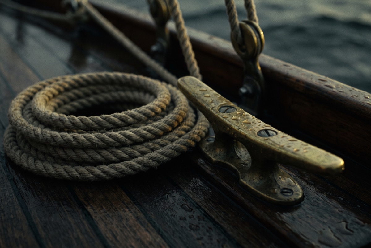 A neatly coiled rope on a ship's deck — careful, seaworthy craftsmanship
